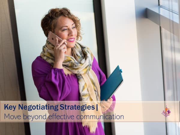 image of woman on cellphone with one of her negotiating strategies to control the conversation