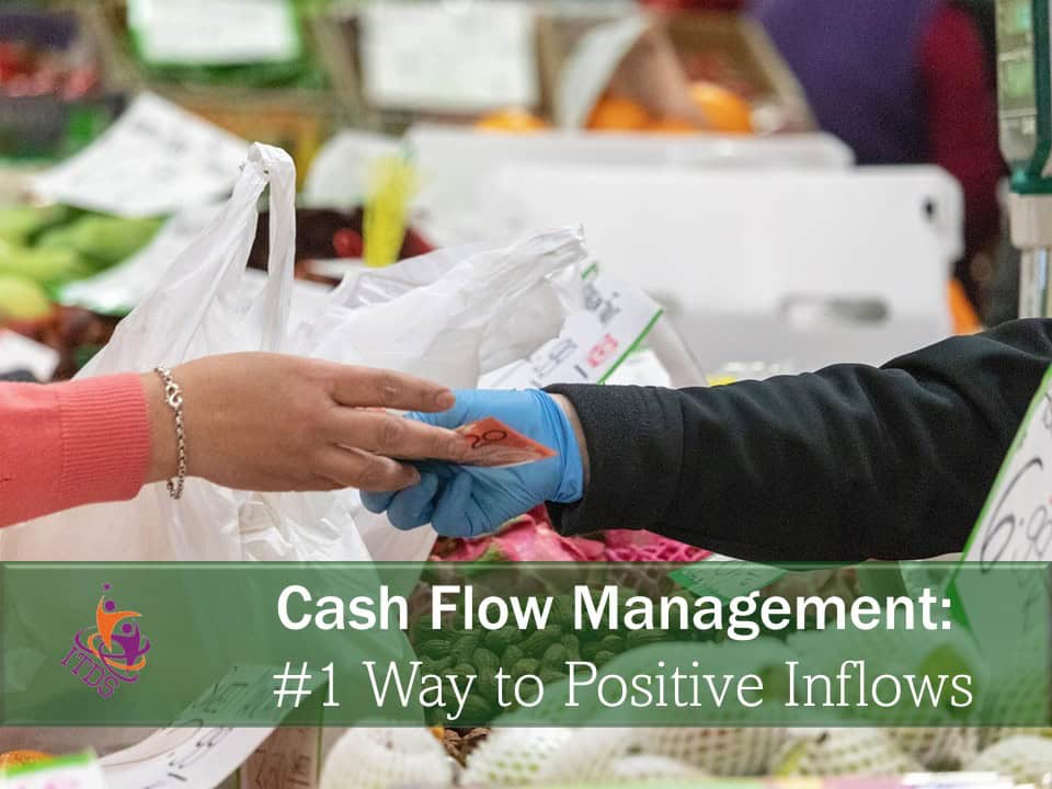 Female hand handing over money as part of retail cash flow management
