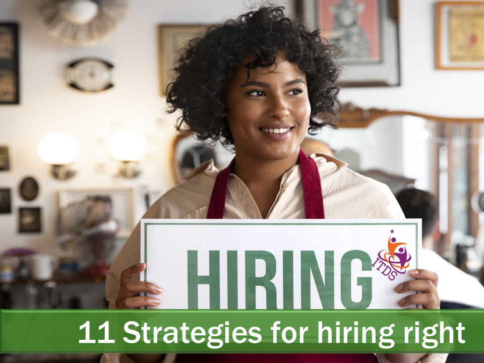 Smiling young female employee holding up hiring sign showing the business is hiring right