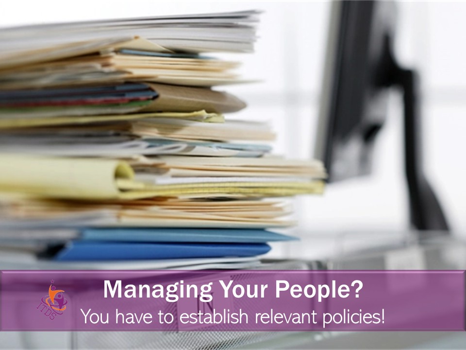 Pile of documents representing relevant policies for managing your people