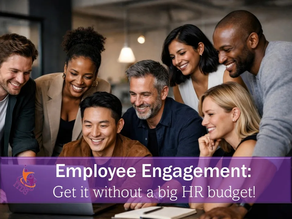 Group of mixed race employees fully engaged with information on a laptop
